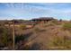 Community pool with lounge chairs, walking path, and beautiful desert landscape views at 13250 W Eagle Feather Rd, Peoria, AZ 85383