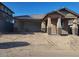 Charming single-story home with a two-car garage and covered front porch on a sunny day at 13250 W Eagle Feather Rd, Peoria, AZ 85383