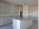 Bright kitchen with white cabinets, granite countertops, and an island, providing ample counter space at 13250 W Eagle Feather Rd, Peoria, AZ 85383