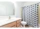 Bright bathroom with light wood vanity and decorative shower curtain at 1344 N Constellation Way, Gilbert, AZ 85234