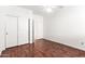 Bedroom with hardwood floors, ceiling fan, and closet with sliding doors at 1344 N Constellation Way, Gilbert, AZ 85234