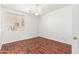 This bedroom has hardwood floors, neutral walls, and a ceiling fan at 1344 N Constellation Way, Gilbert, AZ 85234