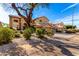 Beautiful home with a well-manicured front yard featuring decorative rock, lush bushes, and a large shade tree at 1344 N Constellation Way, Gilbert, AZ 85234