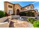 Beautiful home with an arched entrance, well-kept landscaping, and unique outdoor seating at 1344 N Constellation Way, Gilbert, AZ 85234