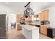 Bright kitchen with an island, stainless steel appliances, and maple cabinets at 1344 N Constellation Way, Gilbert, AZ 85234