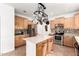 Open kitchen featuring an island, stainless steel appliances, and maple cabinets at 1344 N Constellation Way, Gilbert, AZ 85234