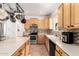 Kitchen features an island, stainless appliances, maple cabinets and stone backsplash at 1344 N Constellation Way, Gilbert, AZ 85234