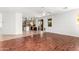 Open-concept living area with wood floors seamlessly connected to a bright kitchen at 1344 N Constellation Way, Gilbert, AZ 85234