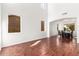 Open-concept living area with wood floors seamlessly connected to a dining area at 1344 N Constellation Way, Gilbert, AZ 85234