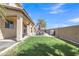 Enjoy outdoor living in this backyard, featuring a covered patio and lush green grass at 1391 E Angie St, Casa Grande, AZ 85122