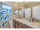 Bathroom featuring double sinks, granite countertop, and a shower with whale-themed curtain at 1391 E Angie St, Casa Grande, AZ 85122