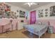 A charming bedroom with pink accents, soft lighting, and colorful decor at 1391 E Angie St, Casa Grande, AZ 85122
