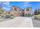 Spacious two-story home with desert landscaping, three-car garage and basketball hoop on the driveway at 1391 E Angie St, Casa Grande, AZ 85122