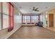 Versatile room with wood-look floors, ceiling fan, and ample natural light, ideal for an exercise room at 1391 E Angie St, Casa Grande, AZ 85122