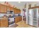Kitchen with stainless steel appliances, granite countertops, breakfast bar, and wood cabinetry at 1391 E Angie St, Casa Grande, AZ 85122