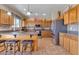 Well-equipped kitchen with stainless steel appliances, granite countertops, large island and breakfast bar seating at 1391 E Angie St, Casa Grande, AZ 85122
