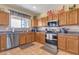 Well-lit kitchen with stainless steel appliances, granite counters, and ample cabinet space for storage at 1391 E Angie St, Casa Grande, AZ 85122