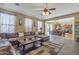 Cozy living room showcasing a brown leather sectional sofa and view to the dining and kitchen areas at 1391 E Angie St, Casa Grande, AZ 85122