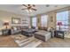 Inviting living room with stylish brown leather sectional sofa, fan, and complementary area rug at 1391 E Angie St, Casa Grande, AZ 85122