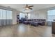 Open living room with a ceiling fan, sectional sofa and hardwood style floors at 1391 E Angie St, Casa Grande, AZ 85122