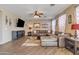 Comfortable living room featuring a sectional sofa, entertainment center, and a ceiling fan at 1391 E Angie St, Casa Grande, AZ 85122