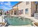 Sparkling pool with baja shelf, water feature, and outdoor living in this backyard at 1391 E Angie St, Casa Grande, AZ 85122