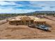 New home construction showing exposed framing and a truck with a trailer with a mountain view background at 13947 E Barwick Dr, Scottsdale, AZ 85262