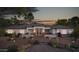 Beautiful single-story home at twilight with desert landscaping and inviting entrance lighting at 13947 E Barwick Dr, Scottsdale, AZ 85262