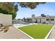 Spacious backyard with artificial turf, desert landscaping, pool, and patio perfect for outdoor living at 1508 W Kiowa Ave, Mesa, AZ 85202