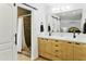 Modern bathroom with double vanity, wood cabinets, and walk-in shower at 1508 W Kiowa Ave, Mesa, AZ 85202