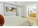 Bright bedroom with a window view, hardwood floors, white wardrobe, and an ensuite bathroom at 1508 W Kiowa Ave, Mesa, AZ 85202