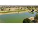 Scenic aerial view of a golf course, highlighting a tranquil lake and verdant landscaping at 1508 W Kiowa Ave, Mesa, AZ 85202