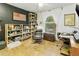 Home office with bookshelves, leather chair, and a well-lit workspace at 1508 W Kiowa Ave, Mesa, AZ 85202