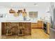 Eat in kitchen features an island with bar stool seating, wood cabinets, and stainless appliances at 1508 W Kiowa Ave, Mesa, AZ 85202