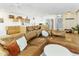 Open-concept living room with a large leather sofa, kitchen, and natural light at 1508 W Kiowa Ave, Mesa, AZ 85202