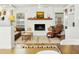 Inviting living room with a brick fireplace, exposed mantle, tiled floors and large windows at 1508 W Kiowa Ave, Mesa, AZ 85202