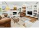 Bright living area with white walls, fireplace, built-in shelves, and modern decor at 1508 W Kiowa Ave, Mesa, AZ 85202