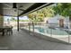 Inviting pool area with mature trees, a covered patio, and secure pool fencing for Gathering fun and relaxation at 1508 W Kiowa Ave, Mesa, AZ 85202