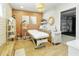 Bright salon featuring an adjustable medical bed, wooden flooring and garage access at 1508 W Kiowa Ave, Mesa, AZ 85202