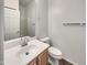 Clean bathroom with a single sink vanity, toilet, and shower at 15240 N 142Nd Ave # 2102, Surprise, AZ 85379
