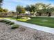 Beautiful community with lush green spaces, a playground, and walking paths at 15240 N 142Nd Ave # 2102, Surprise, AZ 85379