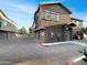 Street view of townhome units and garages within the community with desert landscaping at 15240 N 142Nd Ave # 2102, Surprise, AZ 85379