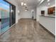 Open-concept living room with a sliding glass door, tile floors and a ceiling fan at 15240 N 142Nd Ave # 2102, Surprise, AZ 85379