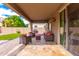 Covered back patio with comfortable seating, ideal for outdoor relaxation and entertaining at 15856 N 76Th Ave, Peoria, AZ 85382