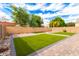 Spacious backyard features lush grass, brick pavers, and a privacy fence, perfect for outdoor enjoyment at 15856 N 76Th Ave, Peoria, AZ 85382