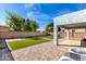 This pristine backyard features a covered patio, synthetic grass, and brick pavers at 15856 N 76Th Ave, Peoria, AZ 85382