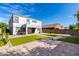 This spacious backyard features an outdoor patio, synthetic grass, and brick pavers at 15856 N 76Th Ave, Peoria, AZ 85382