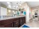 Bathroom featuring double sinks, granite countertops, and decorative vanities at 15856 N 76Th Ave, Peoria, AZ 85382