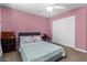 Bright bedroom featuring a sliding closet door, and matching bedside tables at 15856 N 76Th Ave, Peoria, AZ 85382