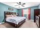 Cozy bedroom with a ceiling fan, comfortable bed, and dresser for ample storage at 15856 N 76Th Ave, Peoria, AZ 85382